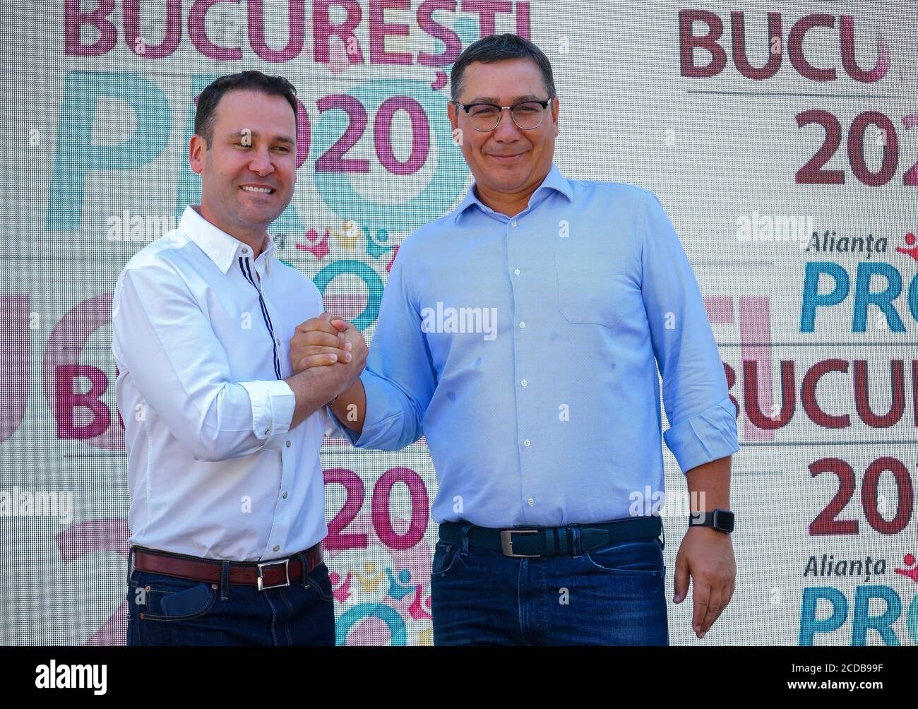 Bucharest, Romania - July 26, 2020: Robert Negoita, candidate for general mayor of Bucharest, and Victor Ponta celebrate the founding of the 'Alianta Stock Photo