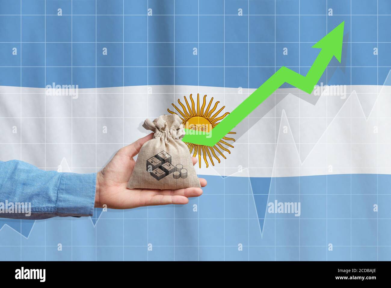 The concept of economic growth in Argentine Republic. Hand holds a bag with money and an upward arrow. Stock Photo