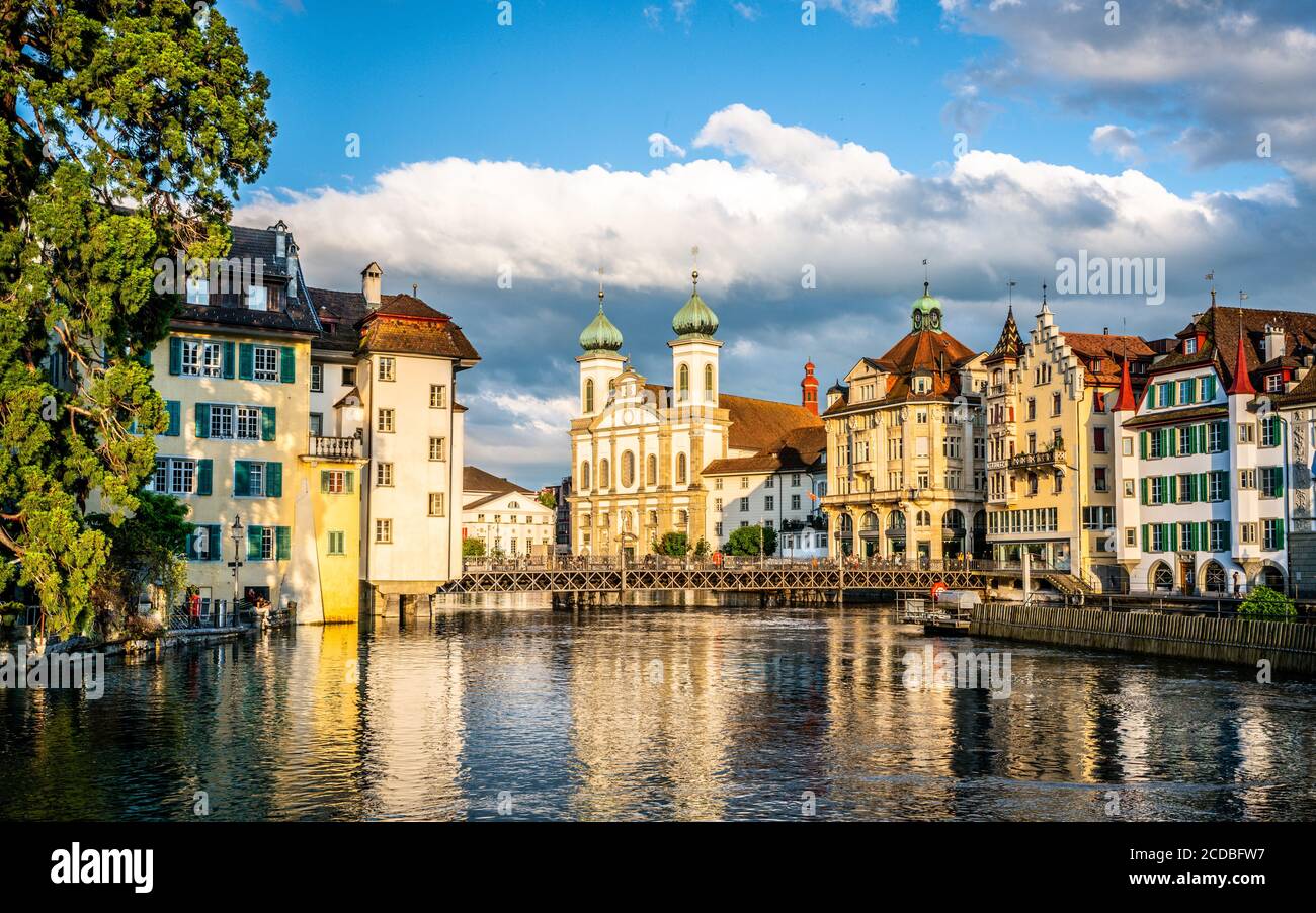 Scenic cityscape of Lucerne old town at sunset with Reussbrucke bridge and Jesuit Church and Reuss river in Lucerne Switzerland Stock Photo