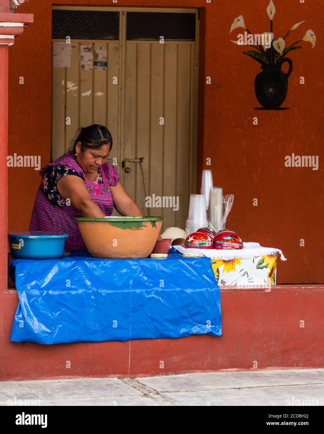A Zapotec woman makes tejate, a traditional drink in Oaxaca, Mexico.  Principal ingredients are toasted maize, fermented cacao beans, toasted mamey pi Stock Photo