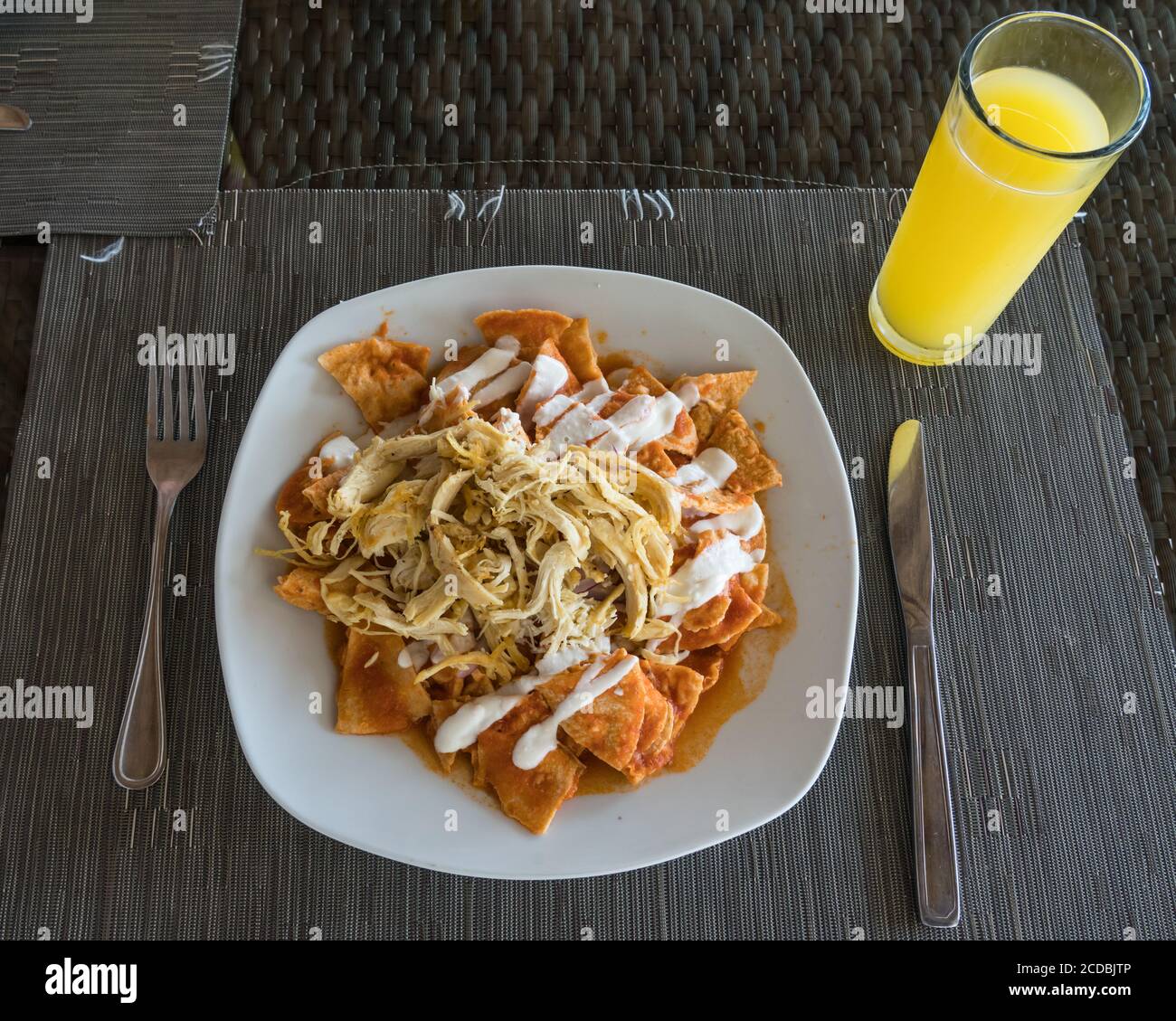 Chilaquiles with shredded chicken and sour cream for breakfast in Oaxaca, Mexico. Chilaquiles