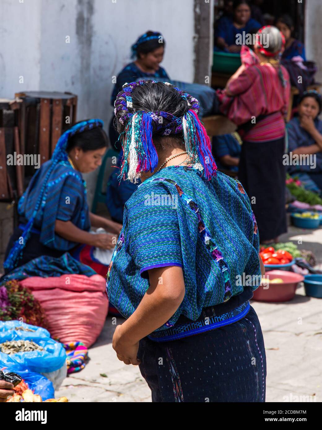A Cakchiquel Mayan woman in the market in the traditional dress of San  Antonio Palopo Guatemala, including the elaborate cinta or hair wrap, woven  blu Stock Photo - Alamy