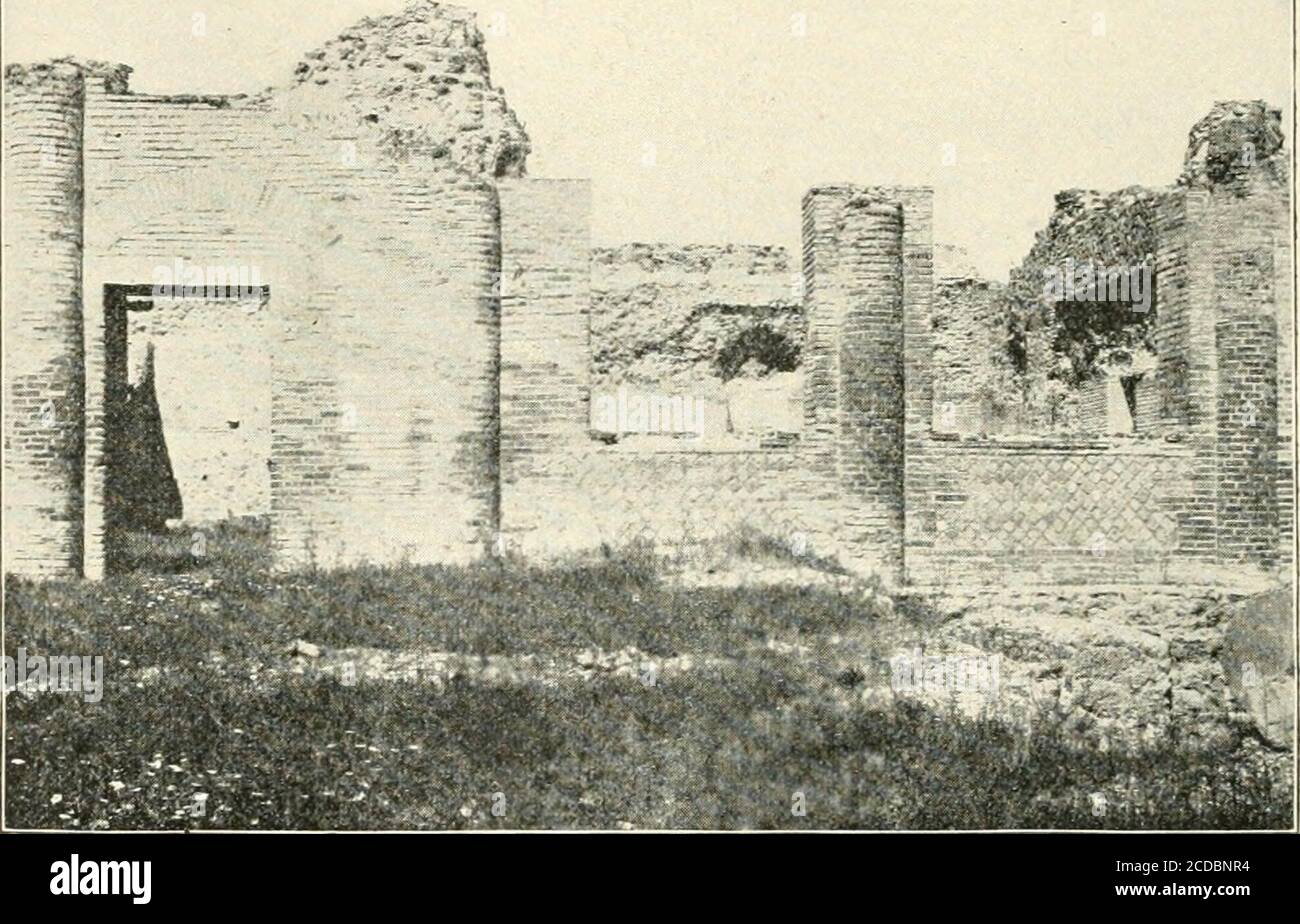 . Pompeii : its life and art . ra ; two of thosebelonging to the tepidarium are seen in Fig. 90. None of therooms were finished, though a hollow floor and hollow walls hadbeen built in the tepidarium, caldarium, and Laconicum. Thebath basins yet lacked their marble linings, and the two furnaces(at x and y) had not been built. Fig. 89. —Plan of the Central Baths. d. Palaestra. q. Tepidarium. k. Swimming tank. r. Laconicum. z, /. Stores. j. Caldarium. p. Apodyterium. x, y. Furnaces. 204 POMPEII Five smaller windows on the southeast side of the caldariumlooked out on a narrow garden, about which Stock Photo