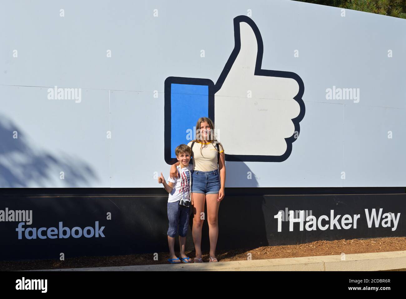 Teenagers proudly posing in front of the Meta (former Facebook) campus, Menlo Park CA Stock Photo