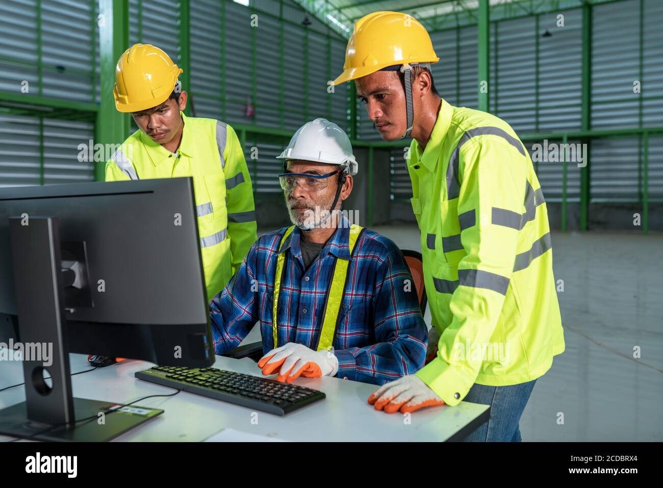 The engineering team working use computer operate in the warehouse design Stock Photo