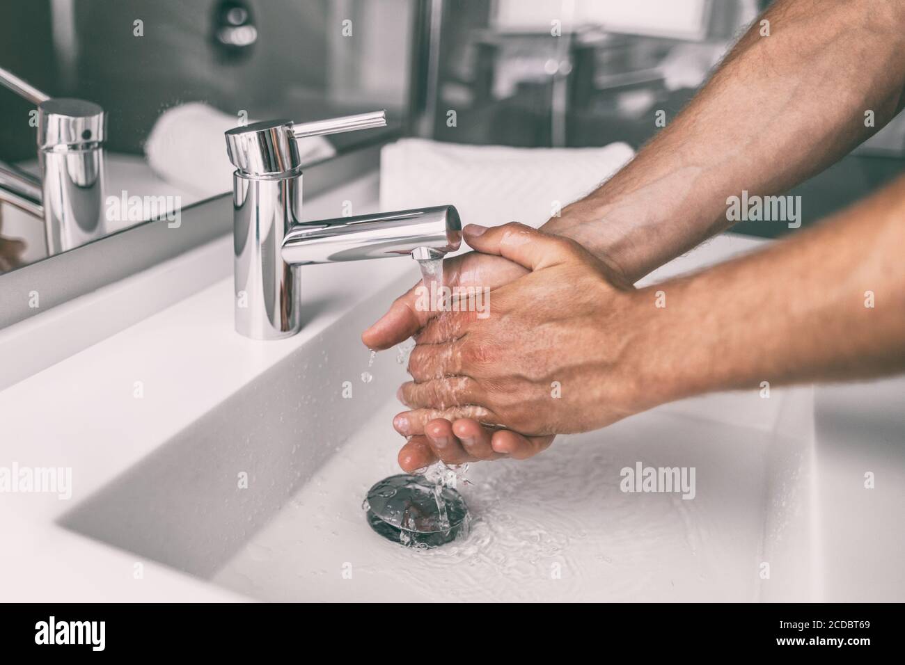 Washing hands rubbing with soap man for winter flu virus prevention, hygiene to stop spreading germs Stock Photo