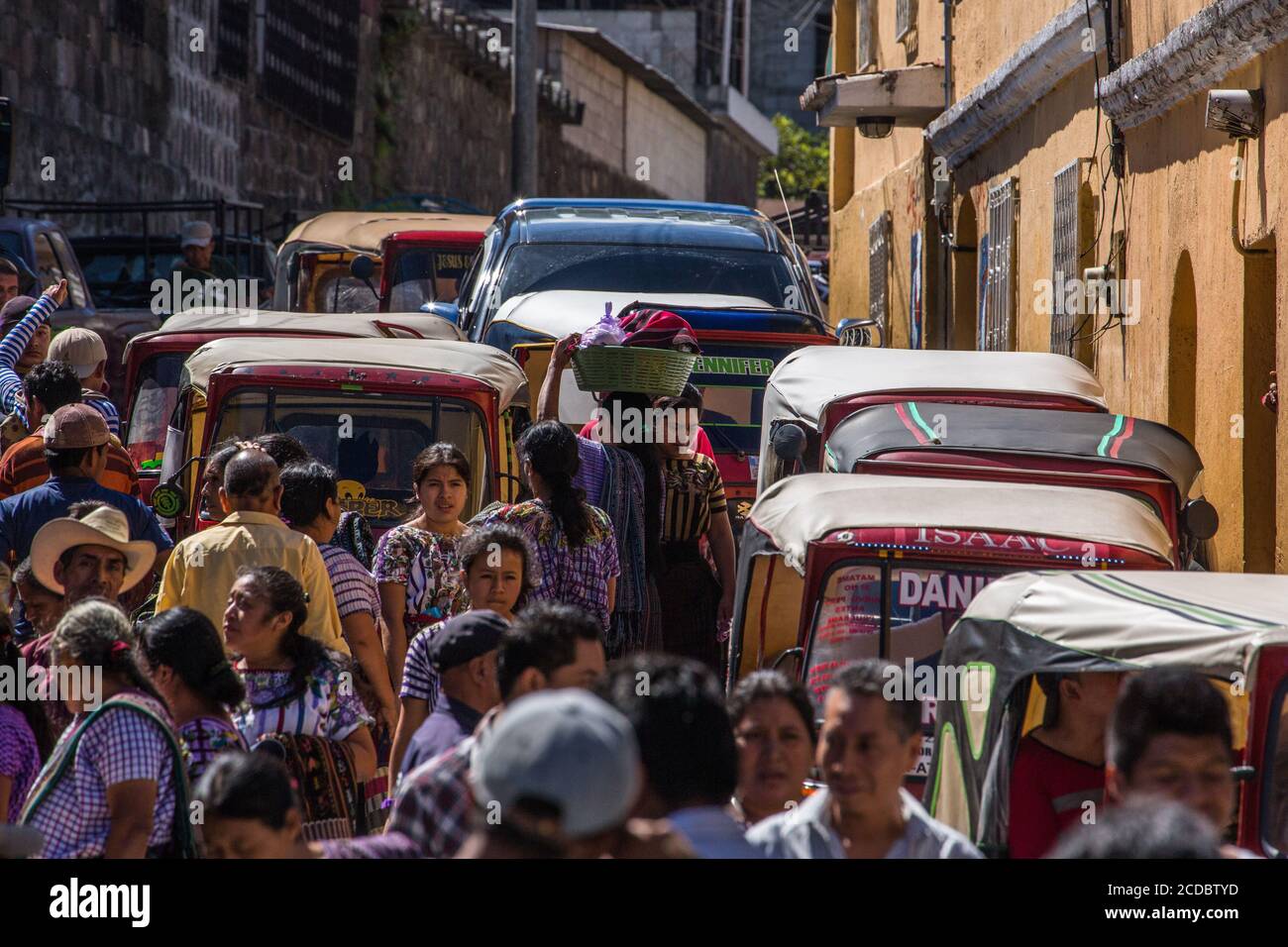 A street scene with heavy pedestrian and vehicular traffic by the weekly open market in Santiago Atitlan, Guatemala. Stock Photo