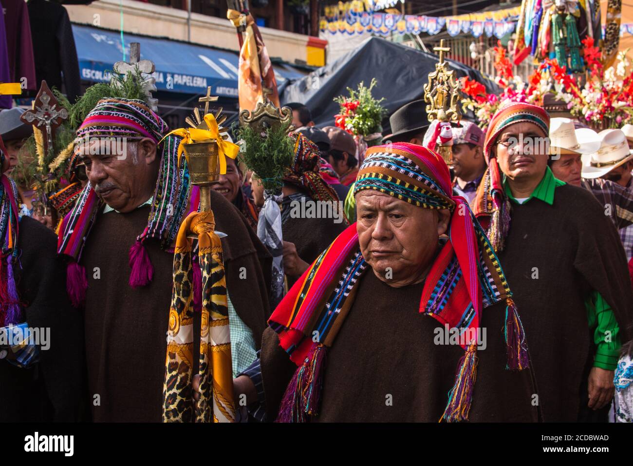 The cofrades or religious officers of the cofradia march in the procession  of the FIesta of Santiago in Santiago Atitlan, Guatemala. They carry their  Stock Photo - Alamy