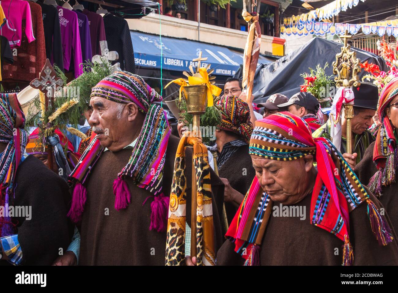 The cofrades or religious officers of the cofradia march in the procession of the FIesta of Santiago in Santiago Atitlan, Guatemala.  They carry their Stock Photo