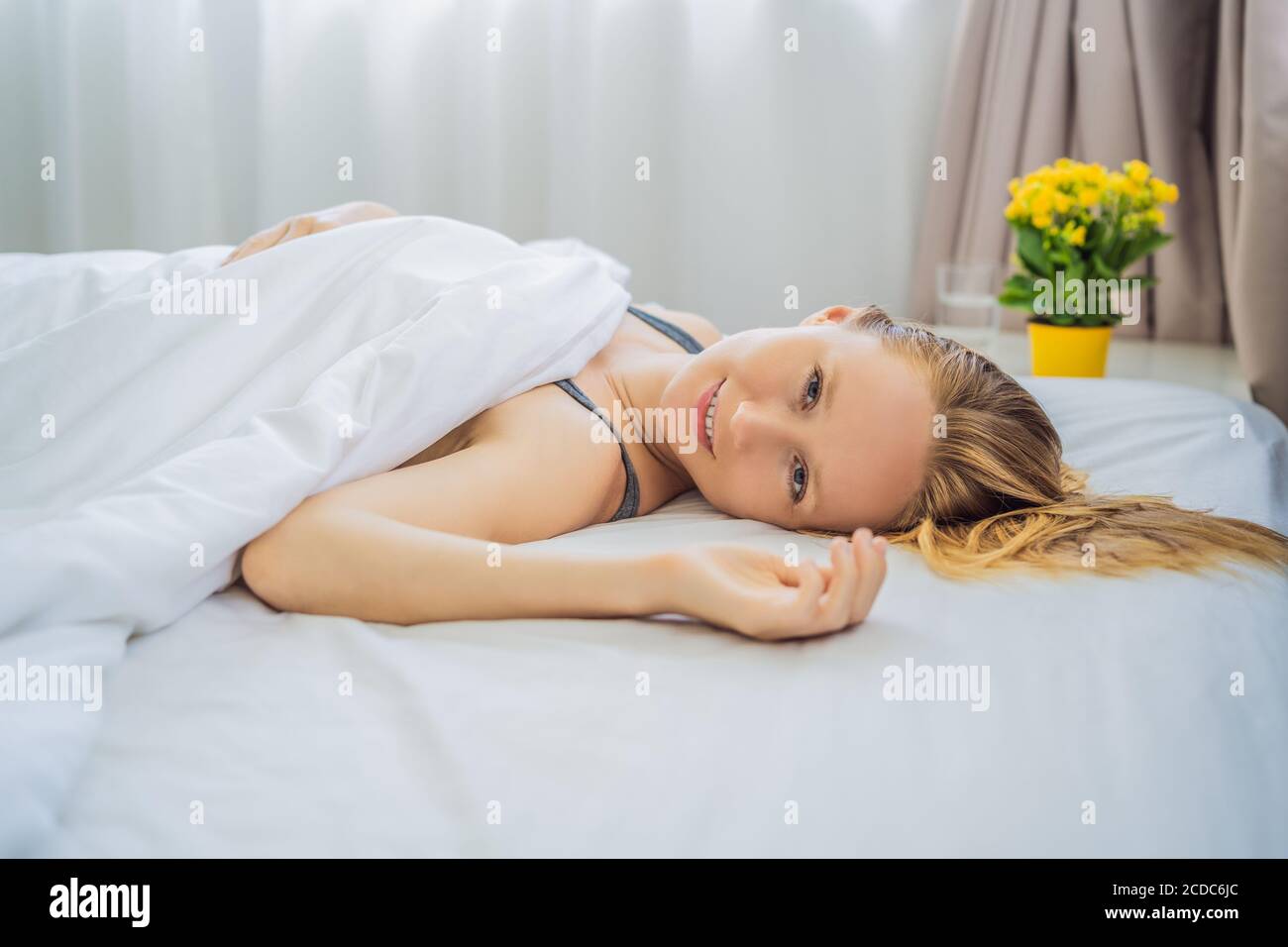 Sleep without a pillow. Young Woman Sleeping In Bed without a pillow