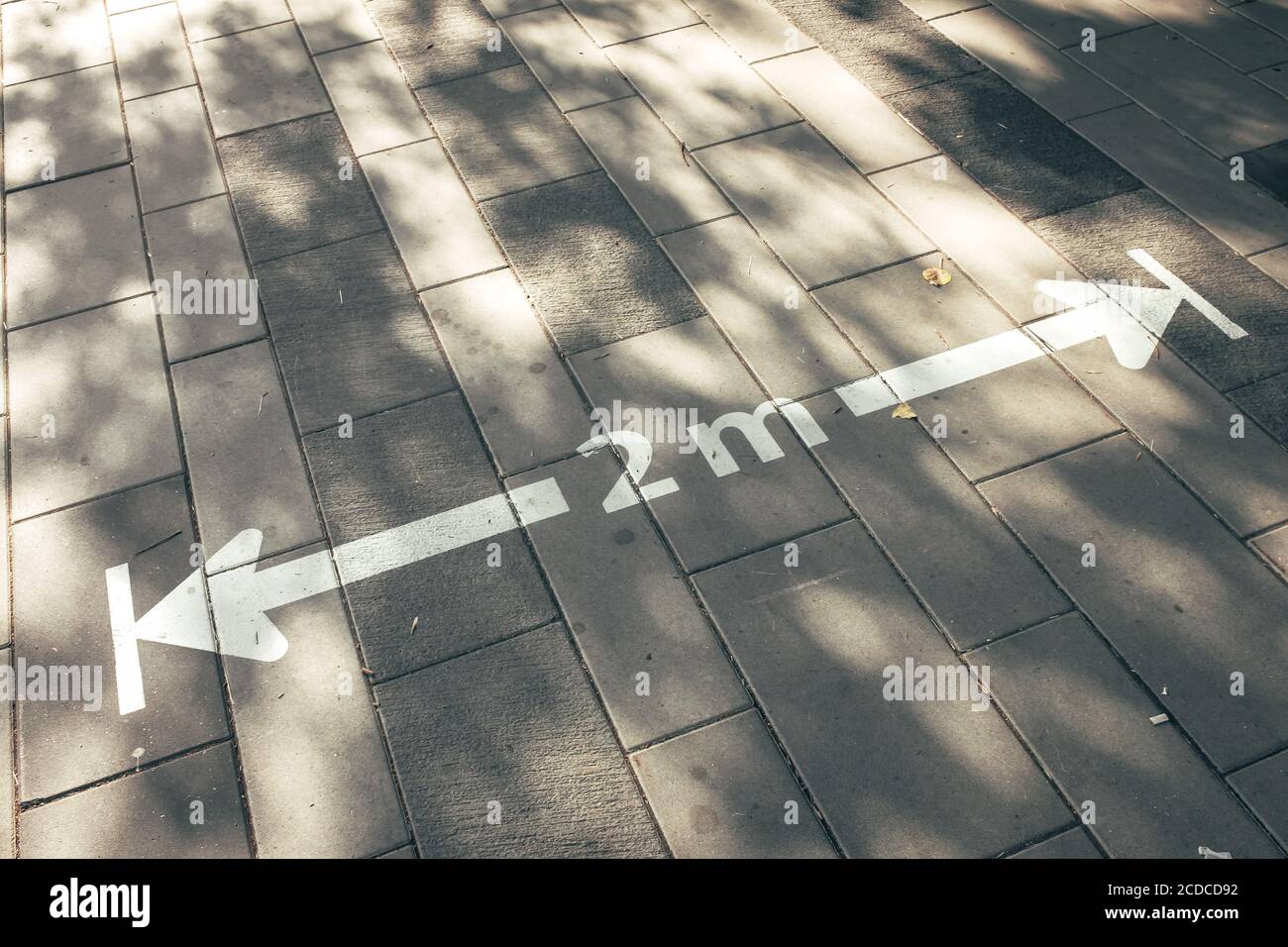 2 meters social distance sign in the golden sun Stock Photo