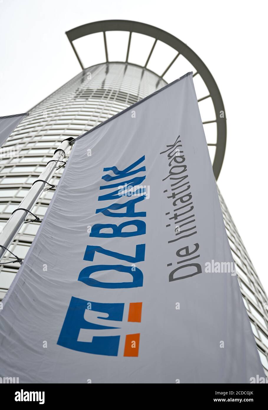 25 August 2020, Hessen, Frankfurt/Main: A flag with the inscription "DZ Bank - Die Initiativbank" hangs in front of the office tower "Westend 1", also known as the "Kronenhochhaus", which belongs to the headquarters of DZ Bank. The Deutsche Zentral-Genossenschaftsbank (DZ Bank) presents figures for the first half of 2020 on 28.08.2020. Photo: Arne Dedert/dpa Stock Photo