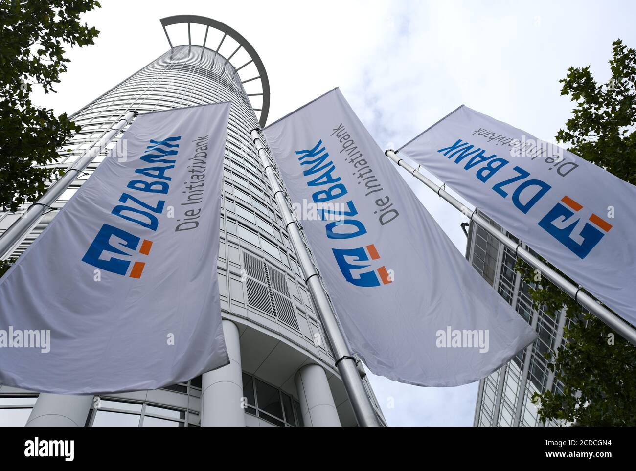 25 August 2020, Hessen, Frankfurt/Main: Flags with the inscription "DZ Bank - Die Initiativbank" are hanging in front of the office tower "Westend 1", also known as the "Kronenhochhaus", which belongs to the headquarters of DZ Bank. The Deutsche Zentral-Genossenschaftsbank (DZ Bank) presents figures for the first half of 2020 on 28.08.2020. Photo: Arne Dedert/dpa Stock Photo