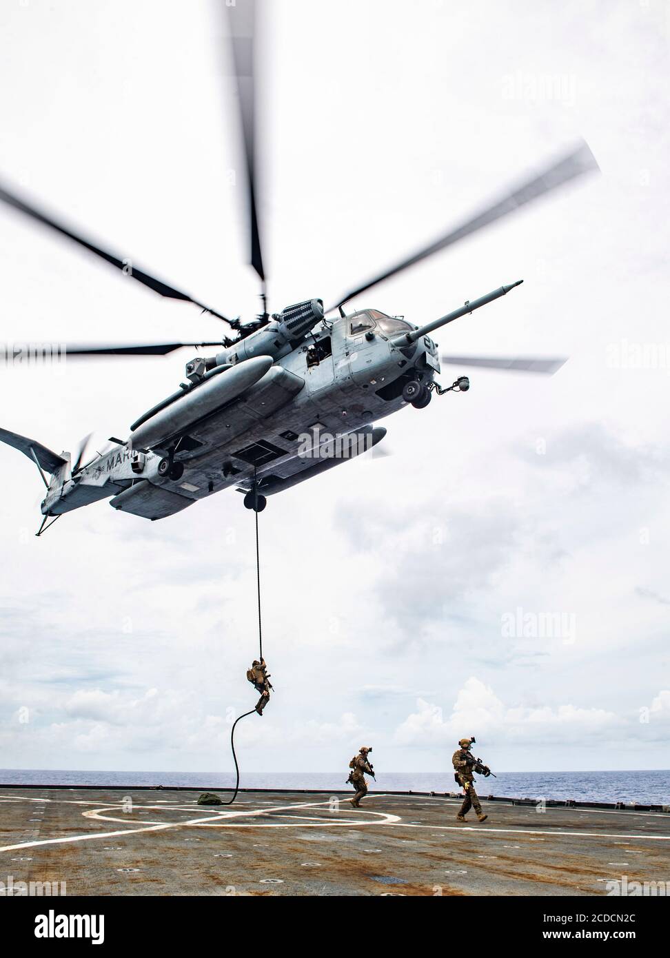 PHILIPPINE SEA (Aug. 26, 2020) Force Reconnaissance Marines with Command Element, 31st Marine Expeditionary Unit (MEU) fast-rope to the flight deck from a CH-53 E Super Stallion heavy lift helicopter during a visit, board, search and seizure exercise aboard the amphibious dock landing ship USS Germantown (LSD 42). Germantown, part of the America Expeditionary Strike Group, 31st MEU team, is operating in the 7th Fleet area of operations to enhance interoperability with allies and partners, and serves as a ready response force to defend peace and stability in the Indo-Pacific region. (U.S. Navy Stock Photo