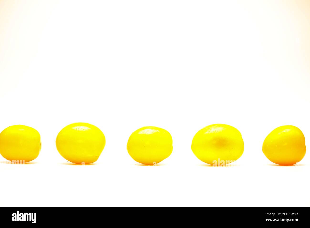 Isolated row of yellow ripe tomatoes over on white background Stock ...