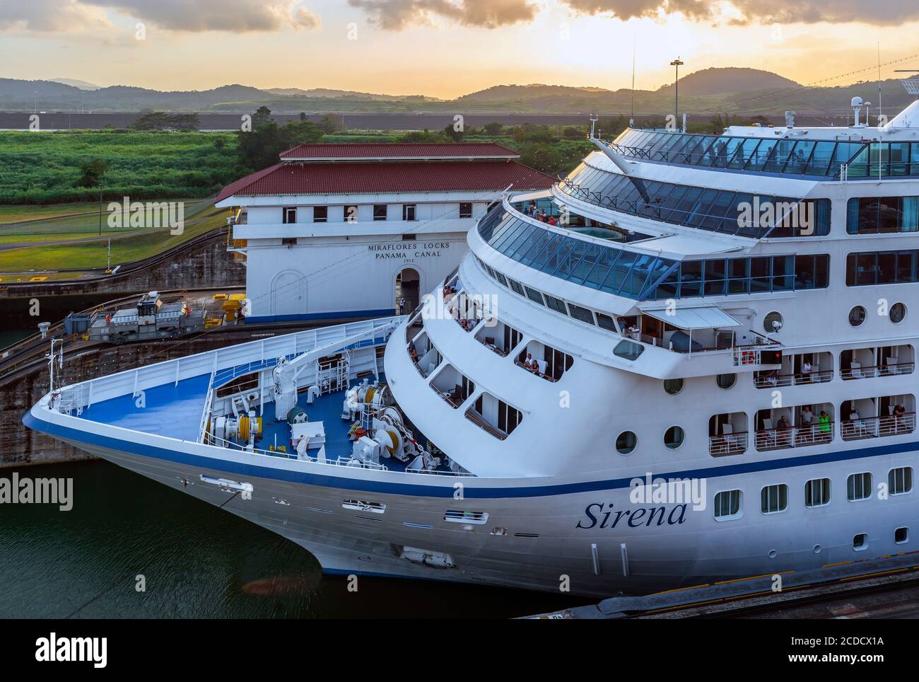 Large cruise ship sailing through the Panama canal at sunset by the Miraflores Locks, Panama City, Panama. Stock Photo