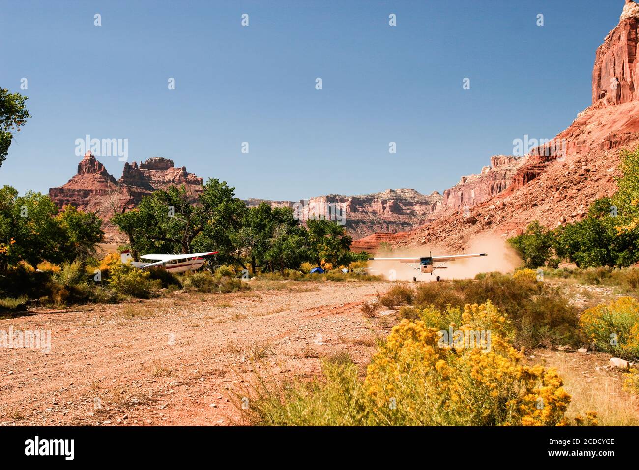 A Cessna 185 Skywagon of the Utah Backcountry Pilots Association takes off from the remote Mexican Mountain airstrip on the San Rafael Swell in Utah. Stock Photo