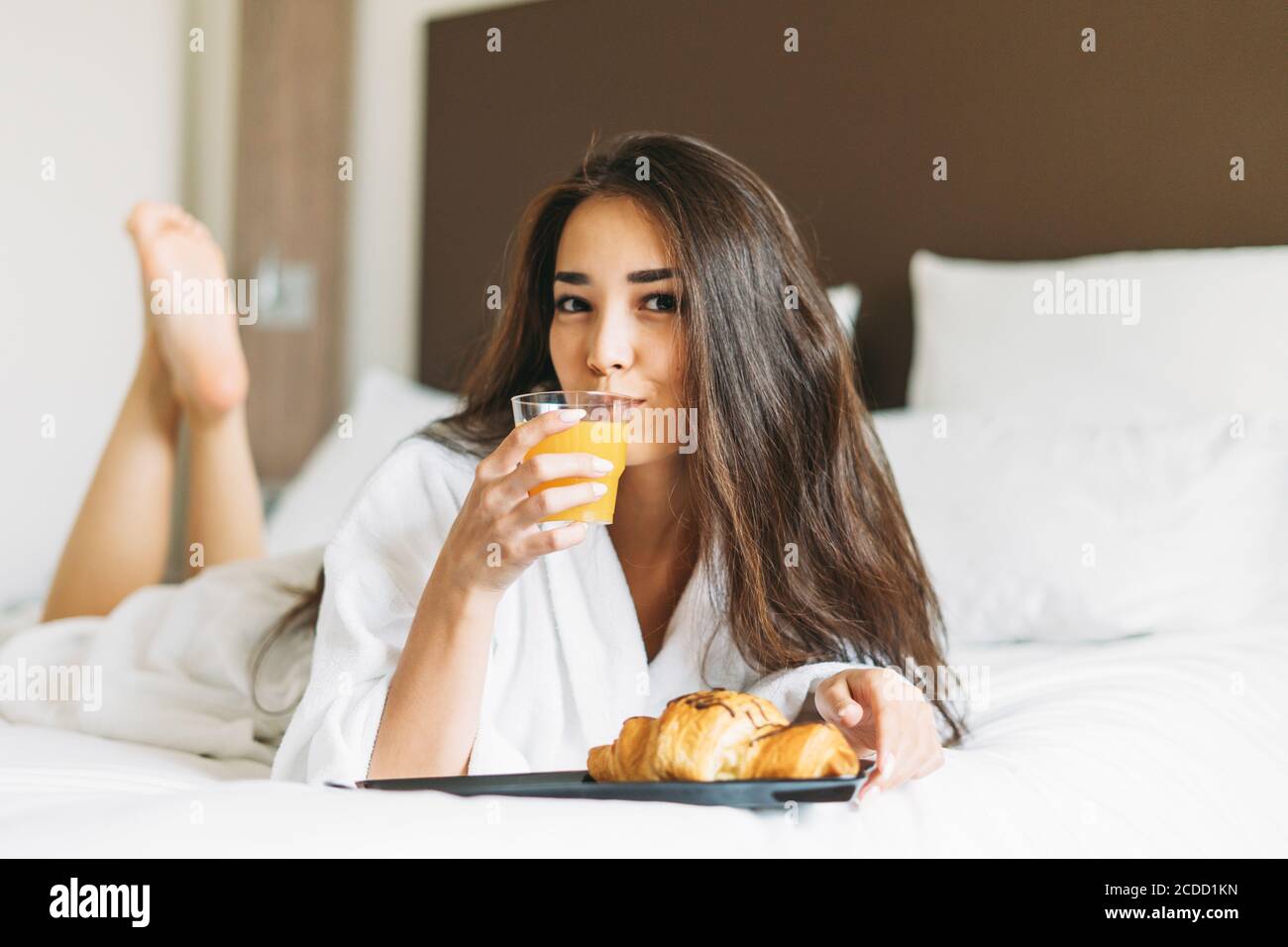 Breakfast In Robe Beautiful young asian woman with long hair in white robe having ...