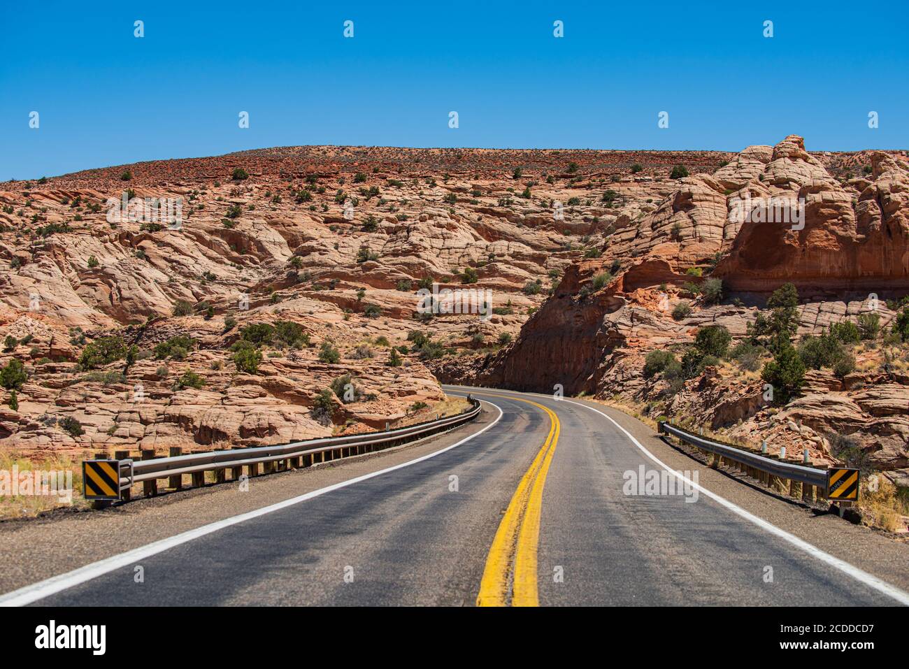 Open road through the field, highland road. Empty scenic highway in Arizona, USA. Desert highway at sunset, travel concept, USA. Stock Photo