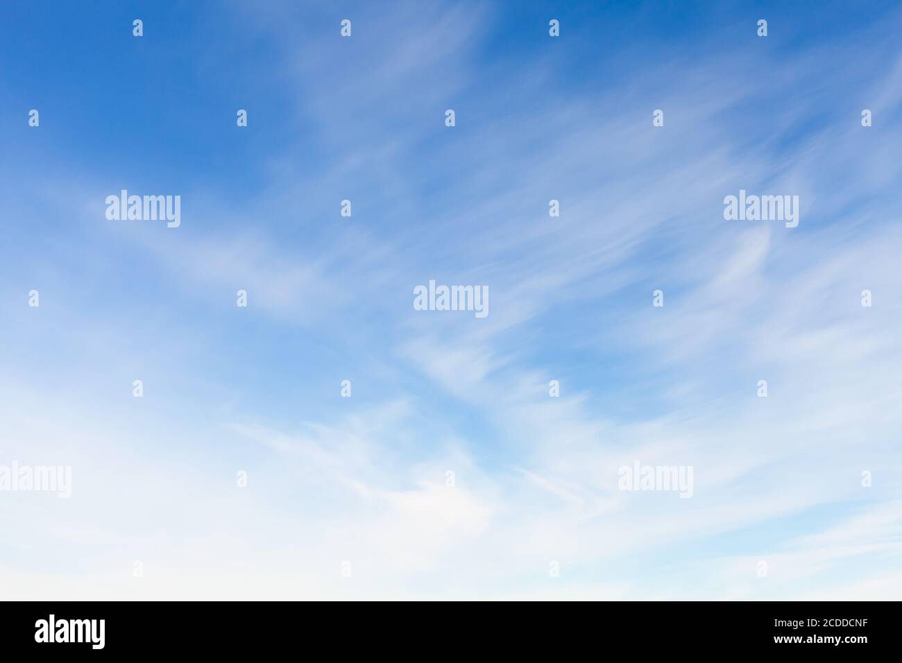 Blue sky with blurred windy clouds at daytime. Natural background photo texture Stock Photo