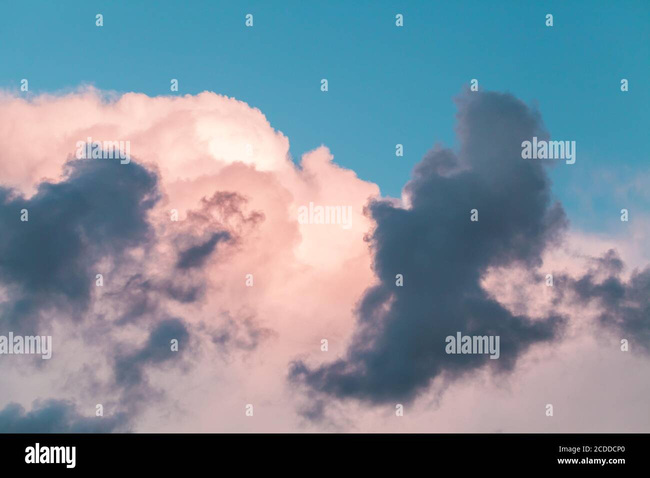 Pink and dark gray clouds in a morning sky, natural background photo texture Stock Photo
