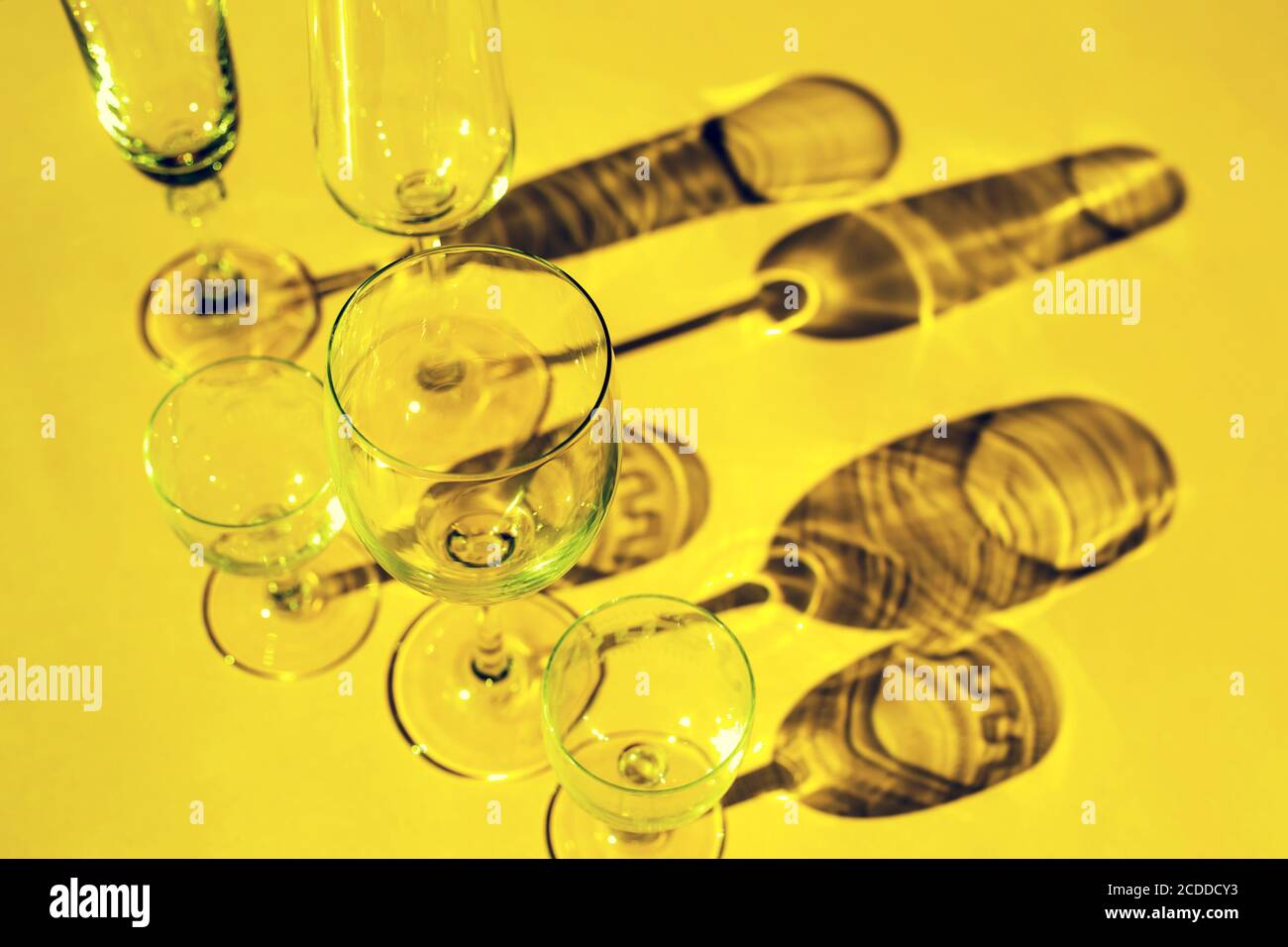 Wine Glasses On A Sunny Table Cast Shadows Sunlight Crystal Glassware Wine Glasses Champagne Flute On Yellow Background Stock Photo Alamy