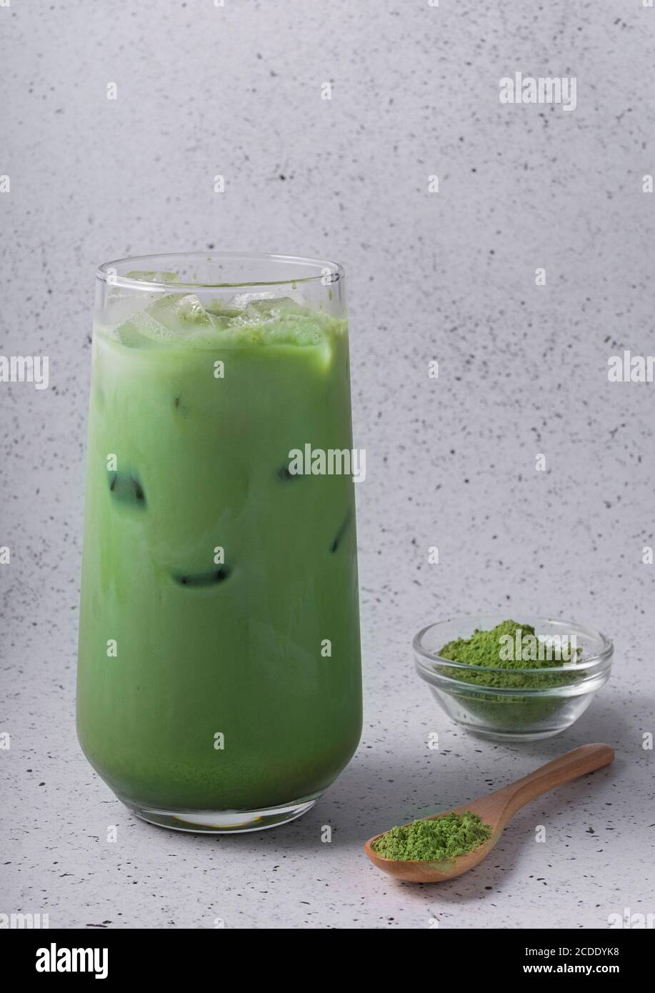 Green tea latte with ice in plastic cup and straw on wooden background.  Homemade Iced Matcha Latte Tea with Milk take away Stock Photo by  ©galitskaya 242393070
