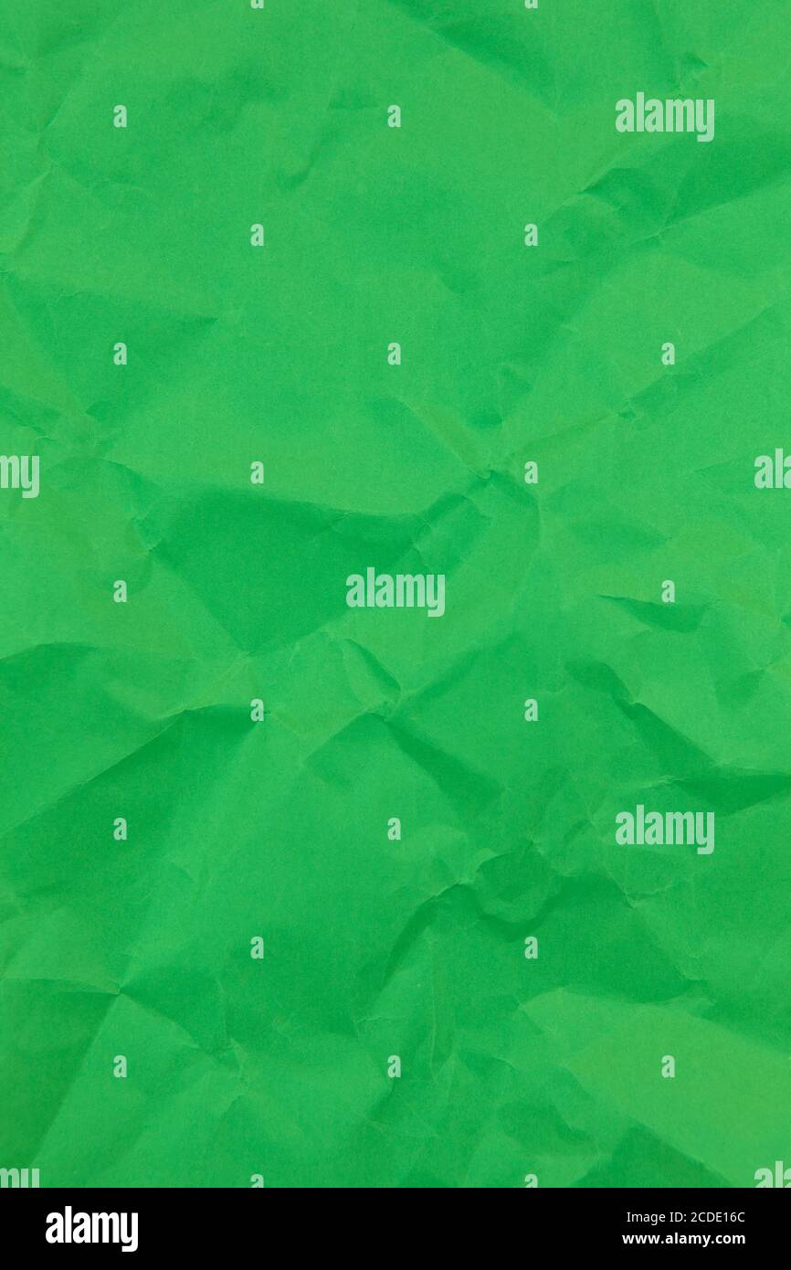 Textured crumpled green paper background. Vertical Stock Photo