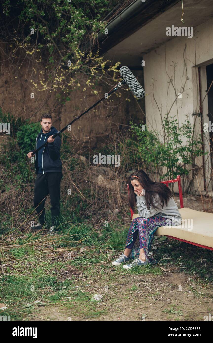 Actor behind the scene. Sound boom operator hold microphone fisher on