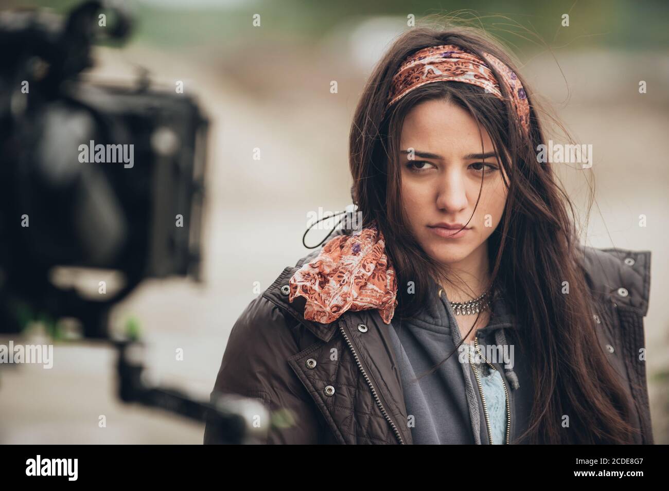 Behind the scene. Actress in front of the camera on the film set outdoor location. Group movie