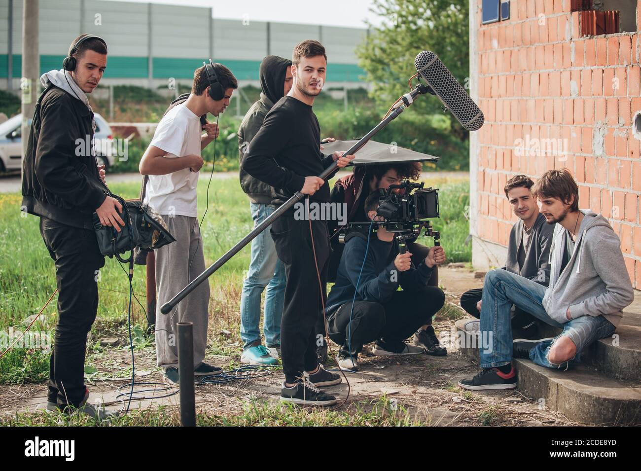 Behind the scene. Film crew team filming movie scene on outdoor location.  Group cinema set Stock Photo - Alamy