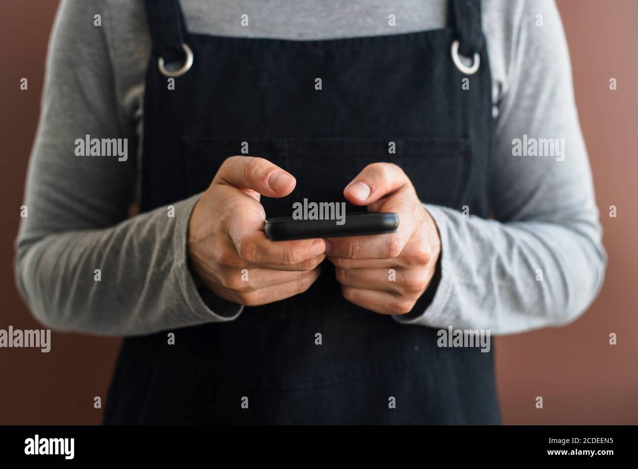 Black apron hi-res stock photography and images - Alamy