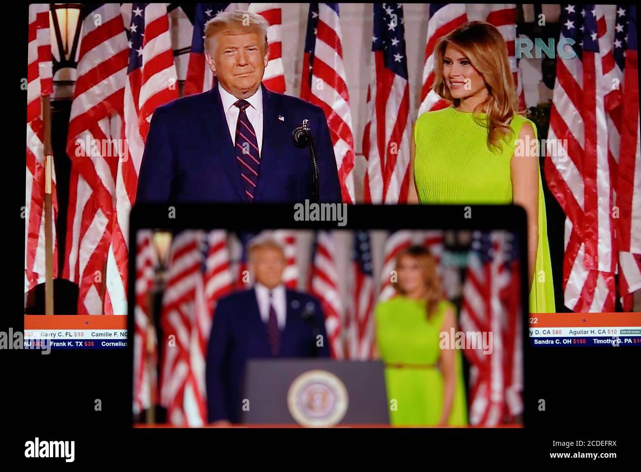 Washington, USA. 28th Aug, 2020. Photo taken in Arlington, Virginia, the United States, on Aug. 27, 2020 shows screens displaying U.S. President Donald Trump and U.S. first lady Melania Trump arriving on stage for the 2020 Republican National Convention. Trump accepted the Republican Party's nomination for reelection in a speech from the White House South Lawn on Thursday night. Credit: Liu Jie/Xinhua/Alamy Live News Stock Photo