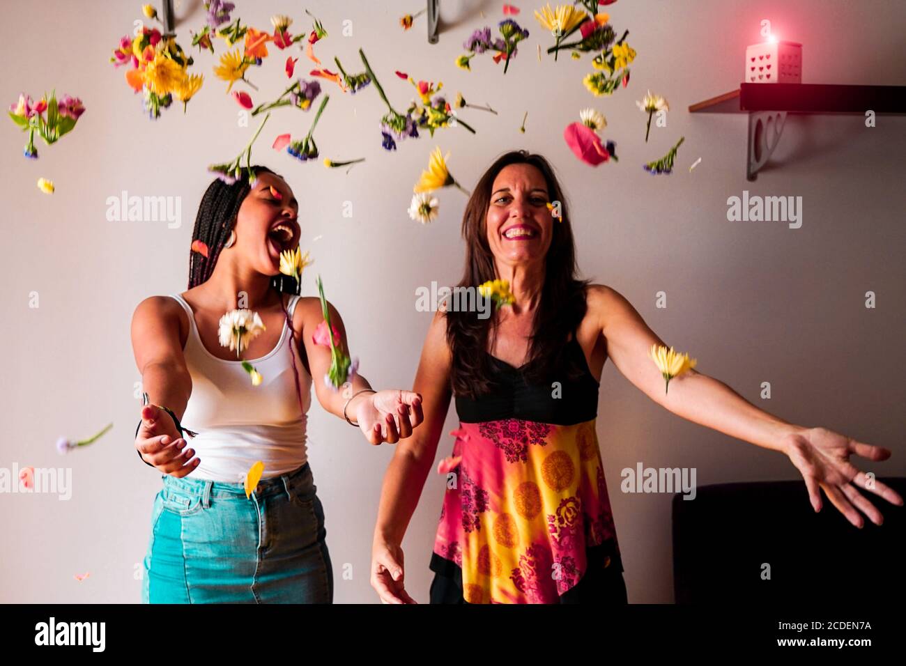 Mother and daughter throwing flowers in the air. Freedom independence liberty concept Stock Photo