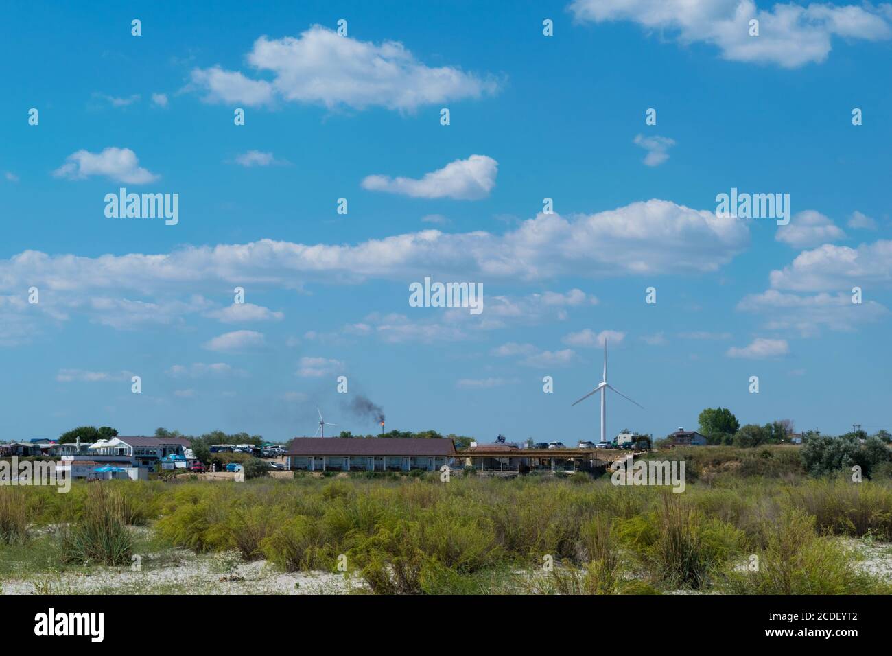 Corbu, Constanta, Romania - August 18, 2019: Buildings powered with green electricity generated by windmils at Corbu Beach, Romania. Stock Photo