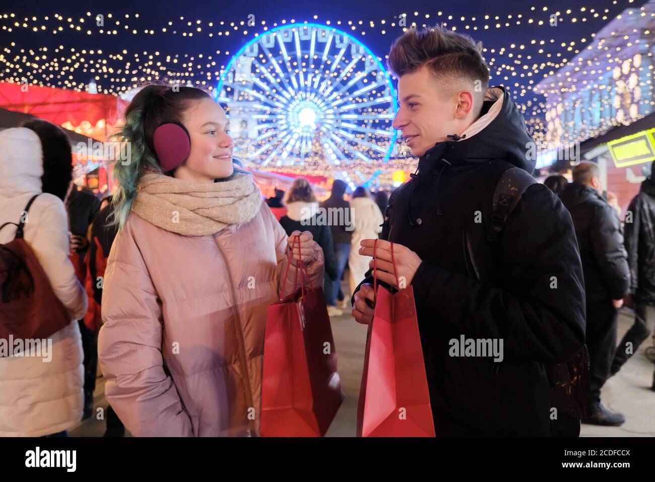 Winter shopping, couple of teenagers with shopping bags Stock Photo