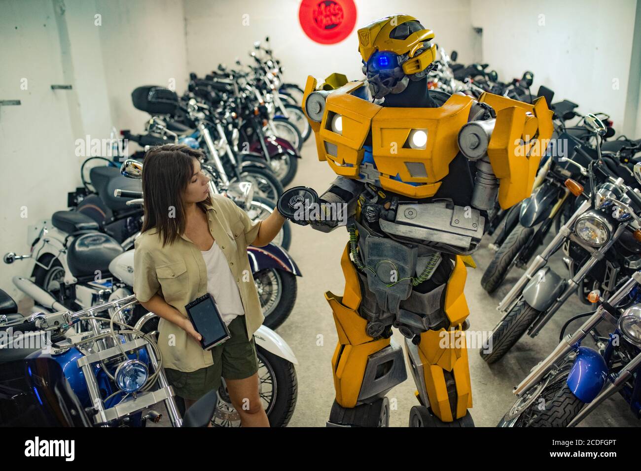 Robot transformer stands in garage near girl Stock Photo Alamy