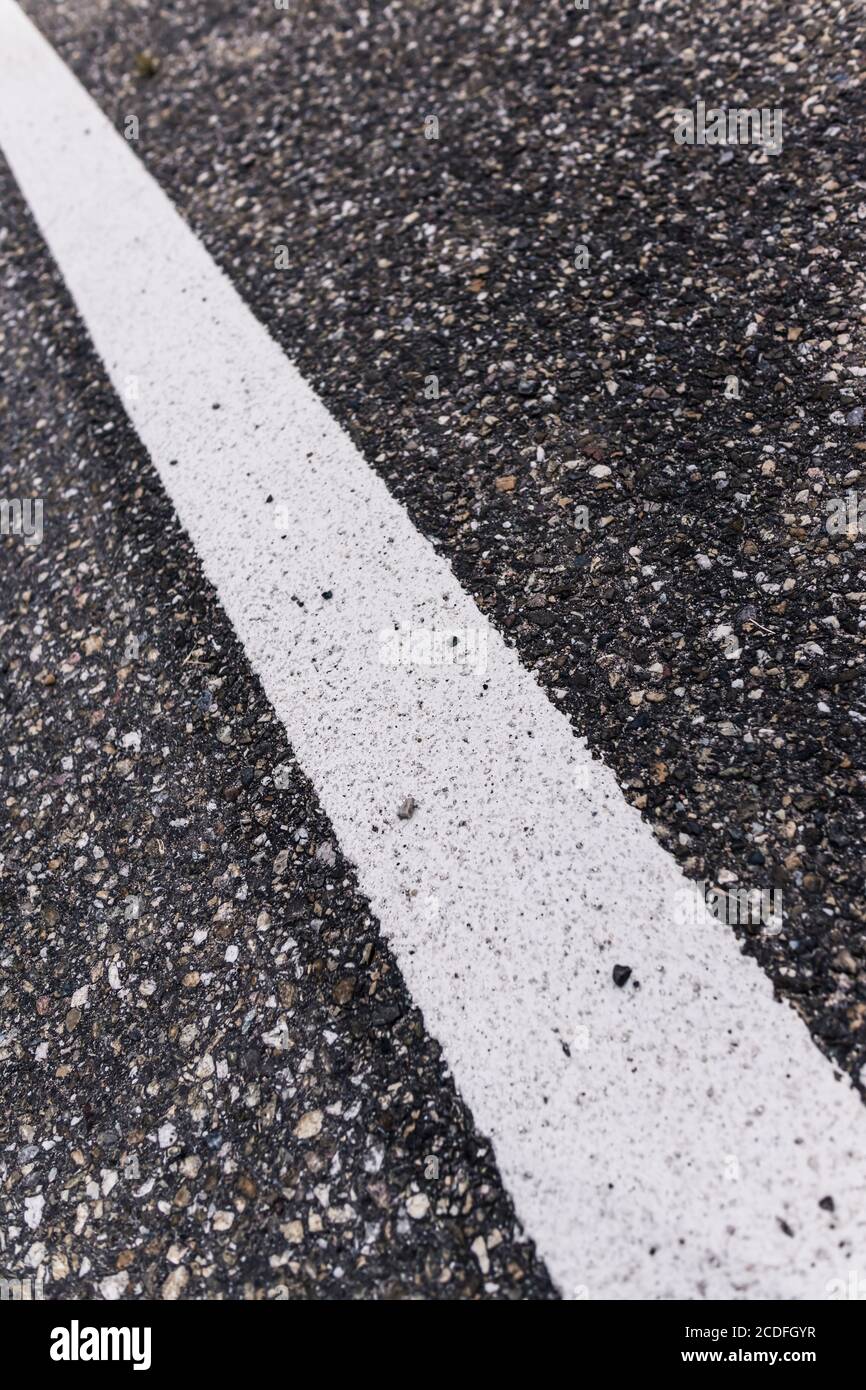Old asphalt road with separation line. Selective focus. Stock Photo