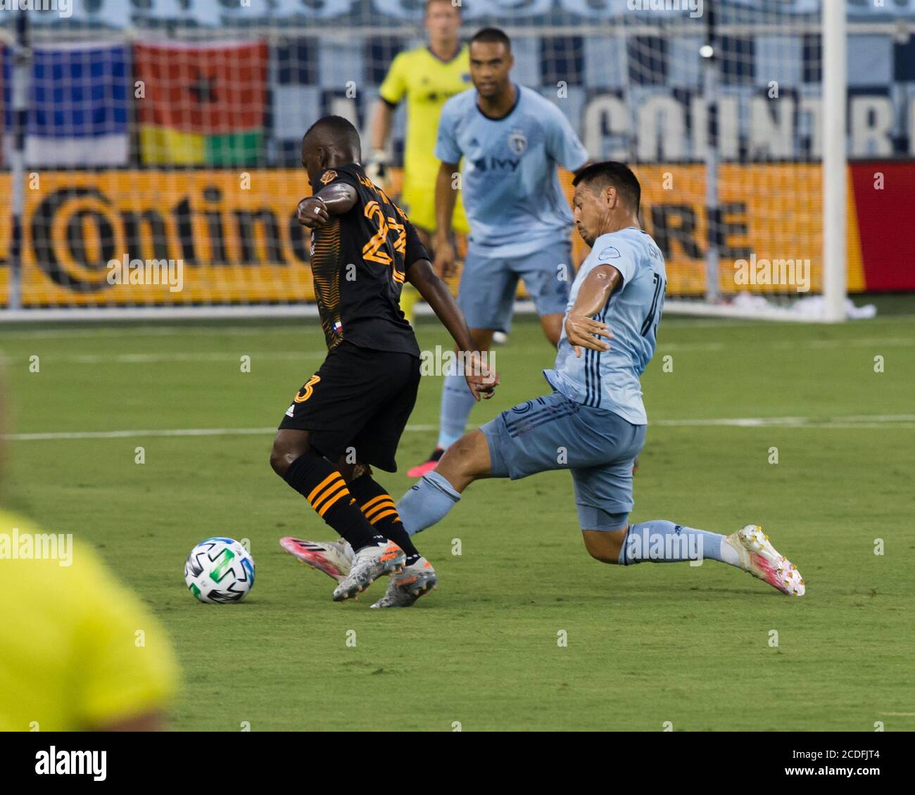 Kansas City, Kansas, USA. 25th Aug, 2020. Sporting KC midfielder Roger Espinoza #15 (r) makes a defensive tackle against Houston Dynamo forward Darwin Quintero #23 (l) during the first half of the game. Credit: Serena S.Y. Hsu/ZUMA Wire/Alamy Live News Stock Photo