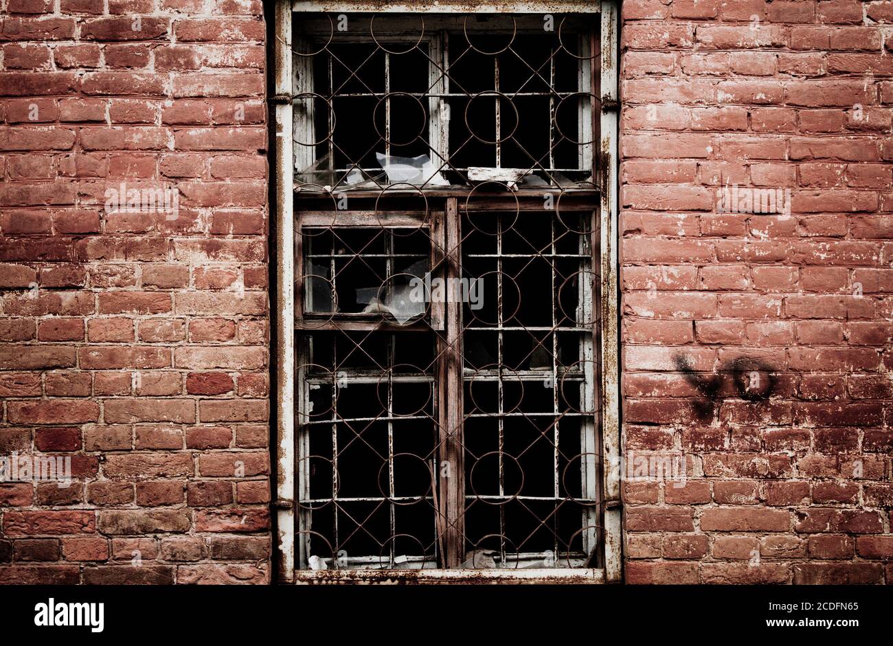 wall of a deserted house with smashed window Stock Photo