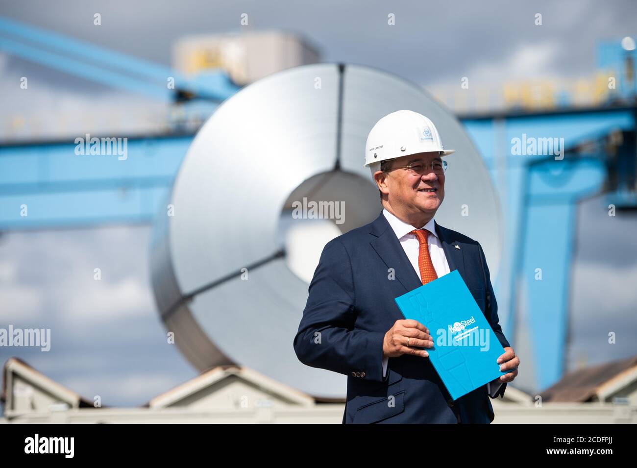 28 August North Rhine Westphalia Duisburg North Rhine Westphalia S Prime Minister Armin Laschet Cdu Visits The Thyssenkrupp Steelworks And Stands In Front Of A Roll Of Sheet Steel Wearing A Protective Helmet Thyssenkrupp
