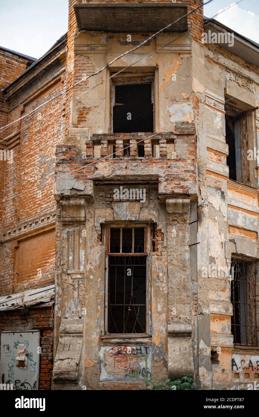 Vertical shot of the facade of an old, abandoned brick building with ...