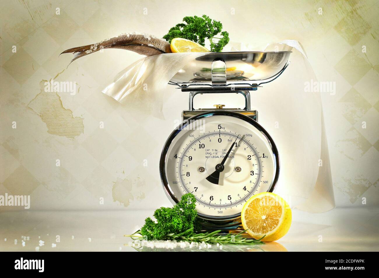 Weight scale with fish and lemons against a grungy, antique background  Stock Photo - Alamy