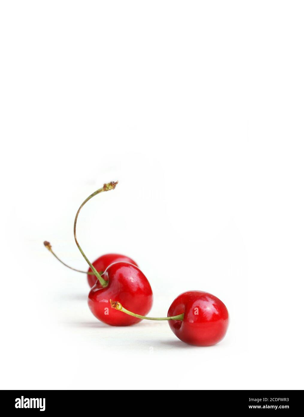 Three little cherries Stock Photo