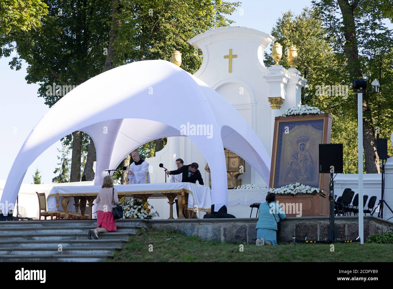 Members of the clergy prepare an outdoor altar to celebrate the Assumption of Mary (15 August) at Aglona Basilica in the Latgale region of Latvia. Stock Photo