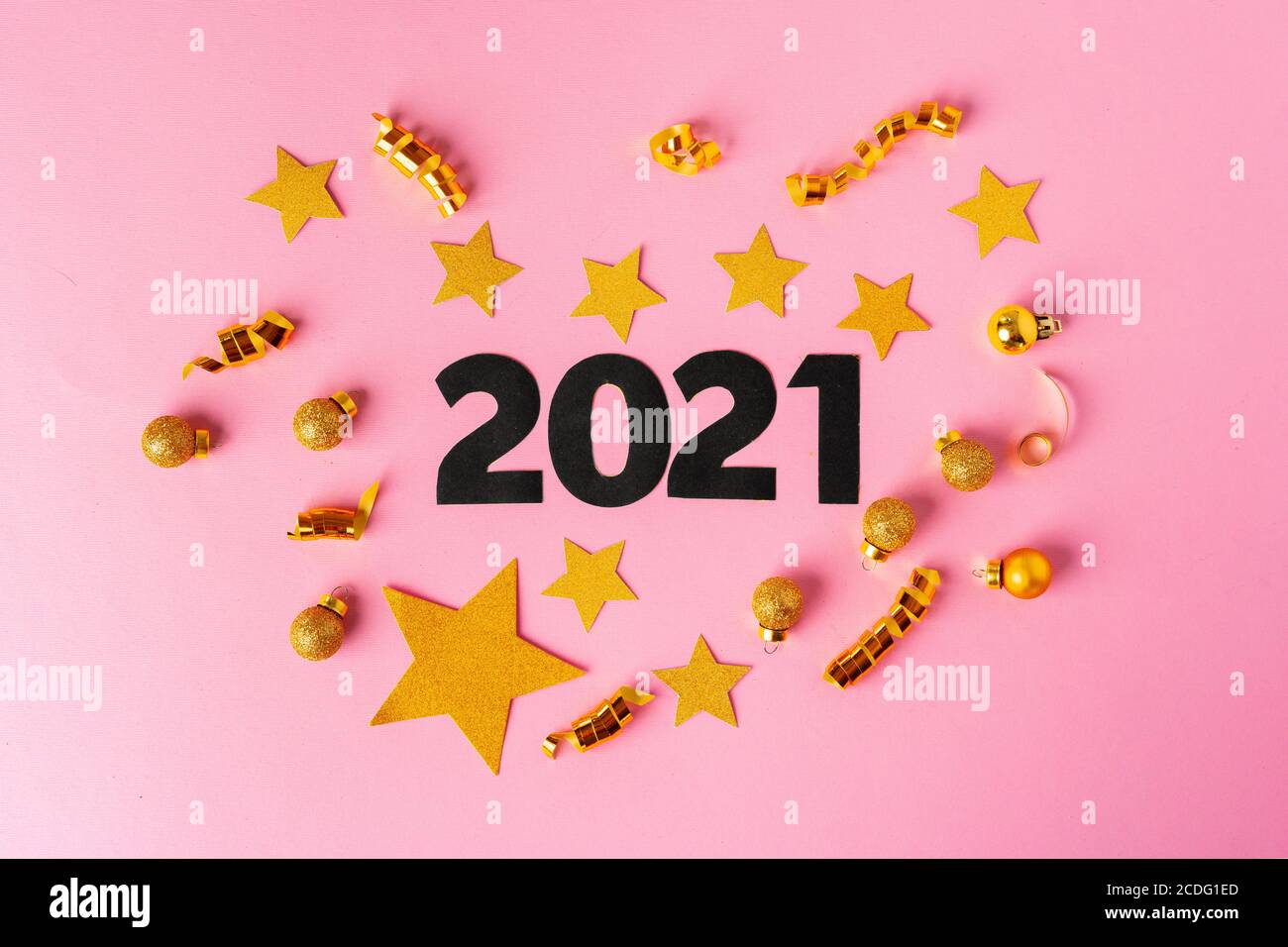 Concept of the year 2021. Golden stars with 2021 numbers on paper