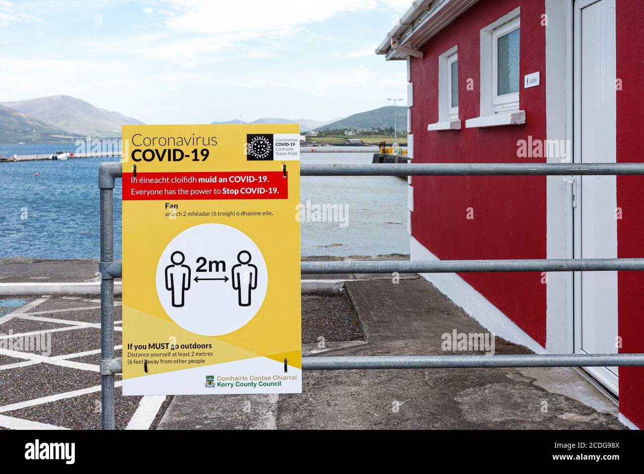 Covid-19 social distancing sign in English and Irish language, County Kerry, Ireland Stock Photo