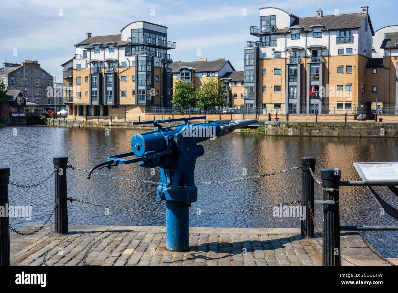 Christian Salvesen harpoon gun with modern apartment blocks on Rennie’s