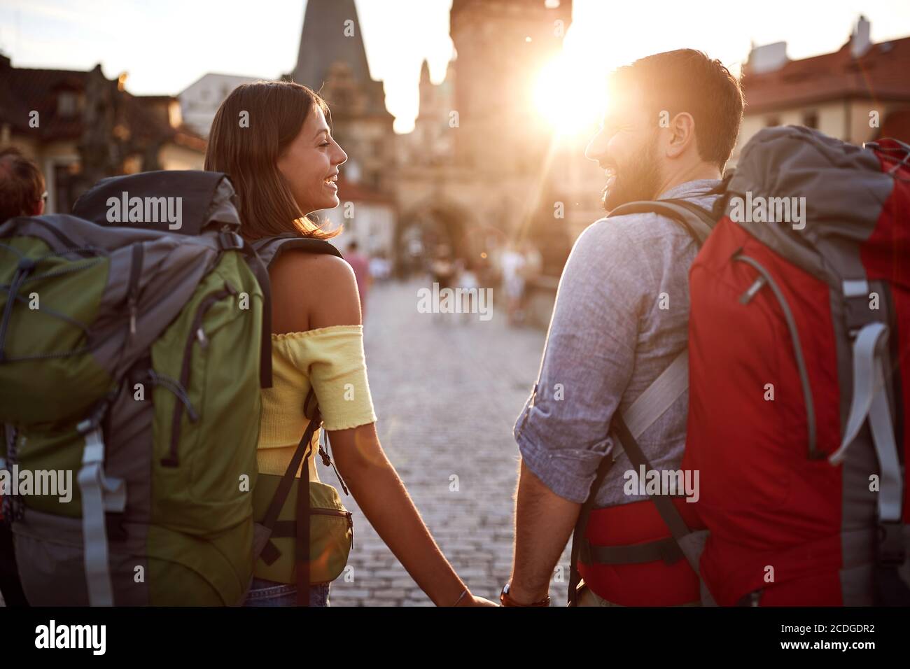 Young couple in love walking in the streets of Prague at sunset. Travel, tourism and people concept. Stock Photo