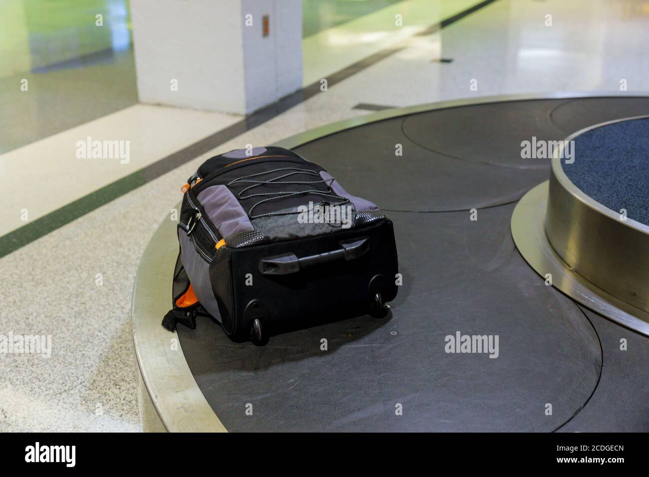 Suitcase or luggage with conveyor belt in the baggage claim at the